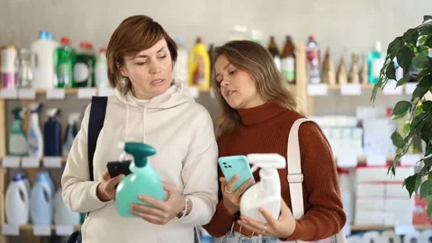 Women clients scans QR code on package and downloads promo code to purchase Stock Footage 328140223