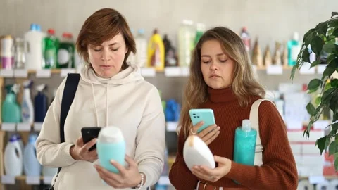 Women clients scans QR code on package and downloads promo code to purchase Stock Footage 329395607