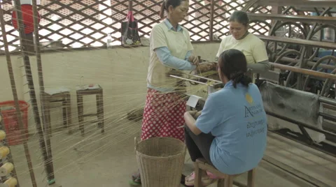 Women combining Silk thread by hand to make fabric in Cambodia Stock-Footage 48011347
