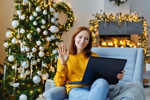 A women communicates remotely using a computer. New year greetings via the In Stock Photos