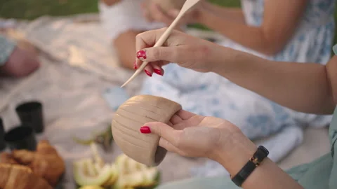 Women concentrate on drawing patterns on clay products with the help of tools in Stock Footage 160909261