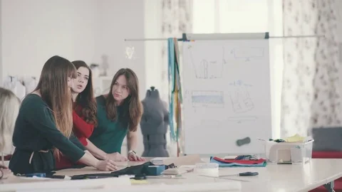 Women in a creative workshop learn to sew and make a pattern Stock Footage 74246104