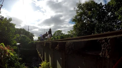 Women crossing old railway road bridge on foot Stock Footage