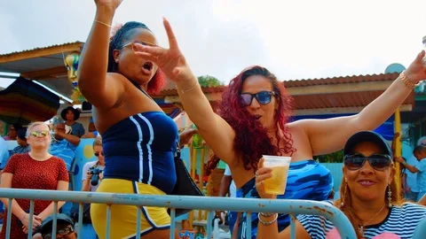 Women dance while watching parade at Carnival in Curacao, Slow Motion Stock Footage 113621385