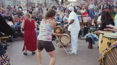 Women dancing at drum circle Friday evenings in downtown Asheville, NC Stock Footage 103434589