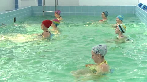 Women do water aerobics in the pool Stock Footage