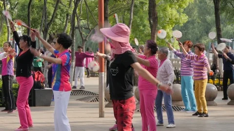 Women doing excercise with badminton racket,Kunming,China Stock Footage