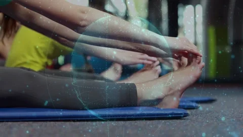 Women doing stretch on mats, leaning, wrapping toes on cue, overlay pulsing over Stock Footage 330144138