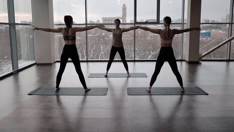 Women doing Triangle exercise in studio Stock Footage 124289551
