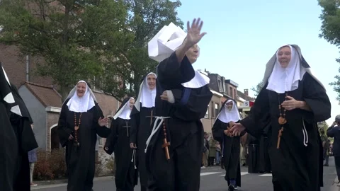 Women dressed as nuns waving during a lo... | Stock Video | Pond5