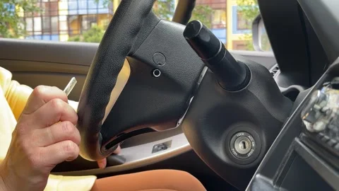 Women driver hand inserting car key and starting engine. Stock Footage 246036464