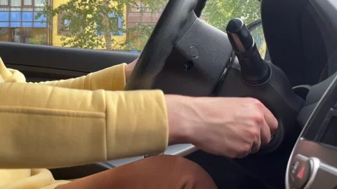 Women driver hand inserting car key and starting engine. Stock Footage 246037182