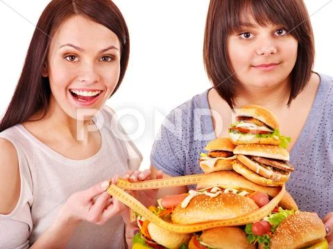 Women eating hamburger. Stock Photos