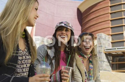 Women Enjoying Drinks Outside Shopping Mall Stock Photos
