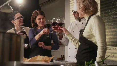 Women Enjoying Wine with Chef While Taking Break During Cooking Master Class Stock Footage 332572606