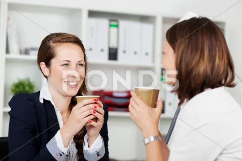 Women executives during a coffee break Stock Photos