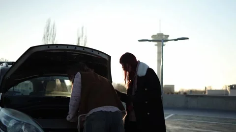 Women experiment fixing car engine in sunlight Stock Footage 332871939
