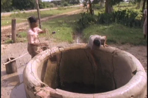 Women fetch water from a well. Stock Footage