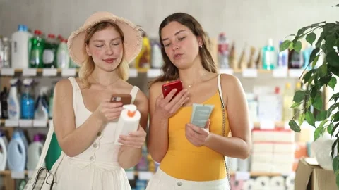 Women friends scanning qr code for sunscreen Stock Footage 329543434