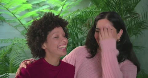 Women friends sharing laughter while leaning on each other after supportive hug Stock Footage 335683129