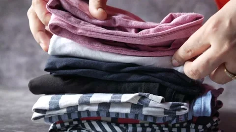 Women hand counting stack of cloths on table. Stock Footage 162562641