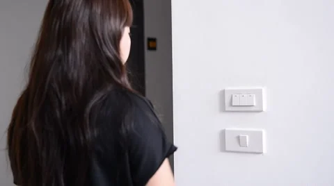 Women hand flips a light switch on and off. Stock Footage 51314301