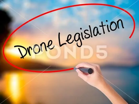 Women Hand writing Drone Legislation with black marker on visual Stock Photos