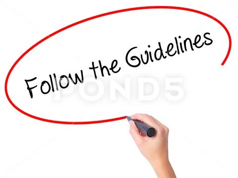 Women Hand writing Follow the Guidelines with black marker on v Stock Photos
