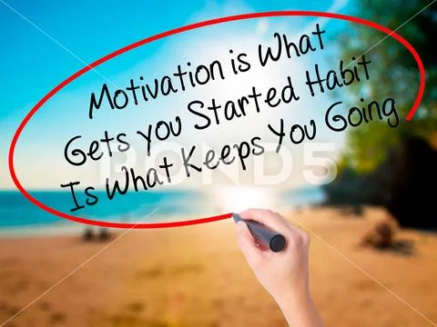 Women Hand writing Motivation is What Gets you Started Habit Is Stock Photos