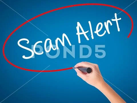 Women Hand writing Scam Alert with black marker on visual scree Stock Photos