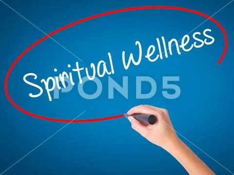 Women Hand writing Spiritual Wellness with black marker on visua Stock Photos