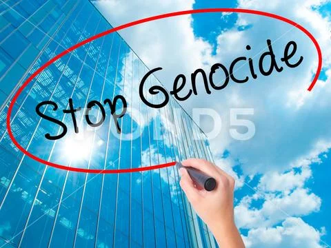 Women Hand writing Stop Genocide with black marker on visual scr Stock Photos