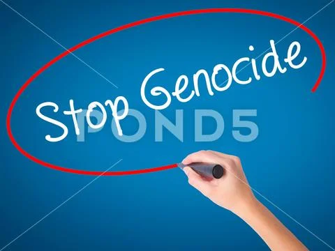 Women Hand writing Stop Genocide with black marker on visual scr Stock Photos