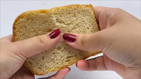Women hands break a piece of bread Stock Footage 311654089