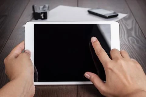 Women hands with tablet computer on table Stock Photos