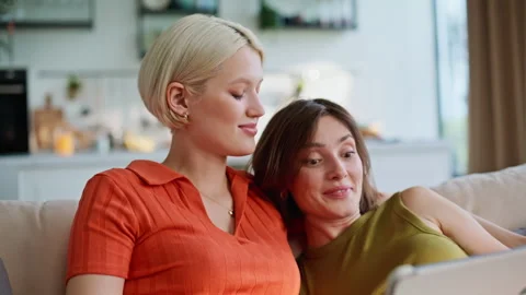 Women hands touching tablet closeup. Lesbian pair using tab computer embracing Stock Footage 335160949