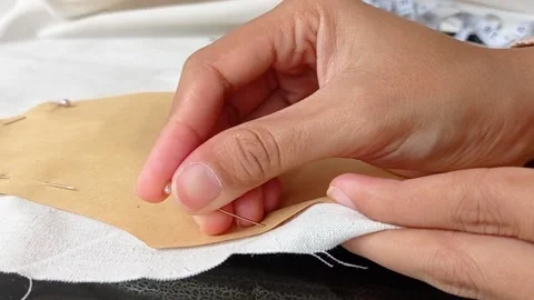 Women hands transferred pattern from paper to fabric Stock Footage 149708587