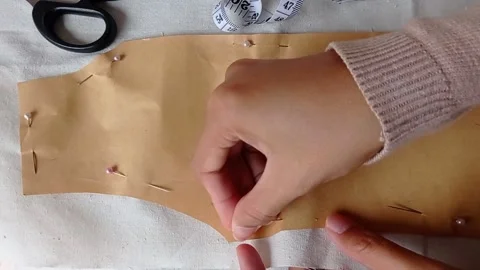 Women hands transferred pattern from paper to fabric Stock Footage 149708598