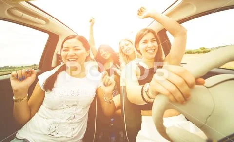 Women having fun driving in a convertible car Stock Photos