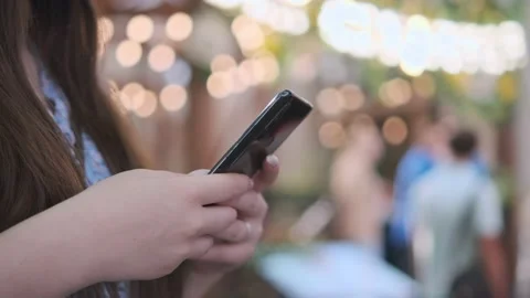 Women holding cell phone using smartphone device in a street cafe. Woman blogger Stock Footage 219242531