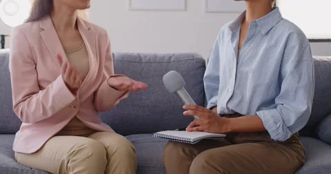 Women in interview conversation, asking holding notepad and microphone Stock Footage 325839867