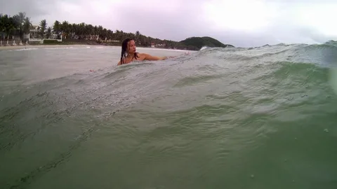 Women jumping in ocean waves. Stock Footage 99813949