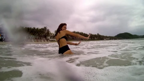 Women jumping in ocean waves. Stock Footage 99813953