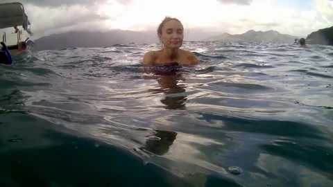 Women jumping in ocean waves. Stock Footage 99814015