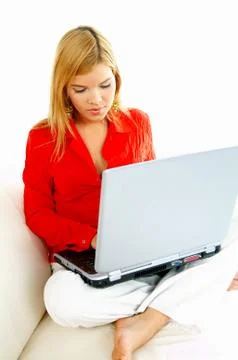Women with laptop on couch Stock Photos
