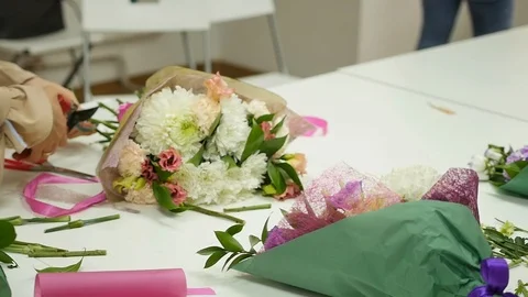 Women learn to make floral design under the guidance of a professional. A group Stock Footage 113403653