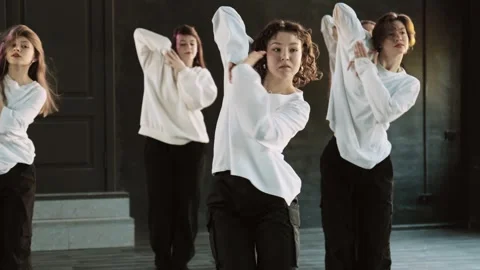 Women learning dance moves in dance room. Young women performing modern dance Video stock 283366004