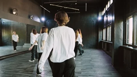 Women learning dance moves in dance room. Choreographer enter dance studio. Video stock 285381416