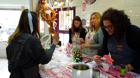 Women learning decorative candle making at a craft workshop Stock Footage 334555619