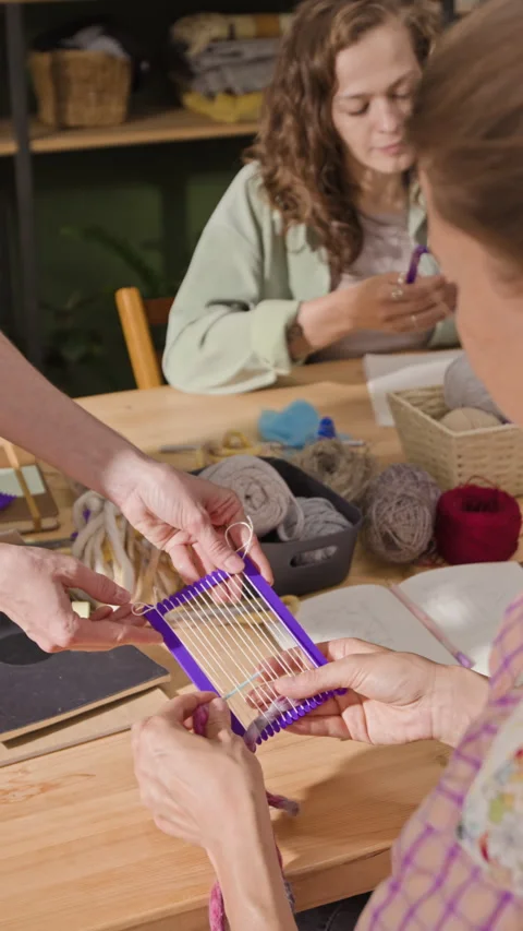 Women Learning Textile Weaving on Small Loom in Craft Workshop Stock Footage 341956441